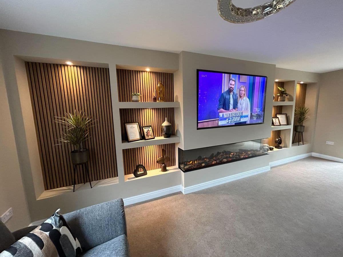 Bespoke media wall with TV, electric fireplace and recessed LED shelving