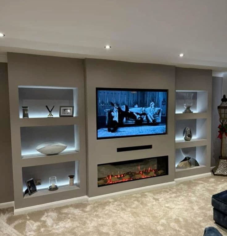 Modern media wall with linear fireplace and ambient shelf lighting