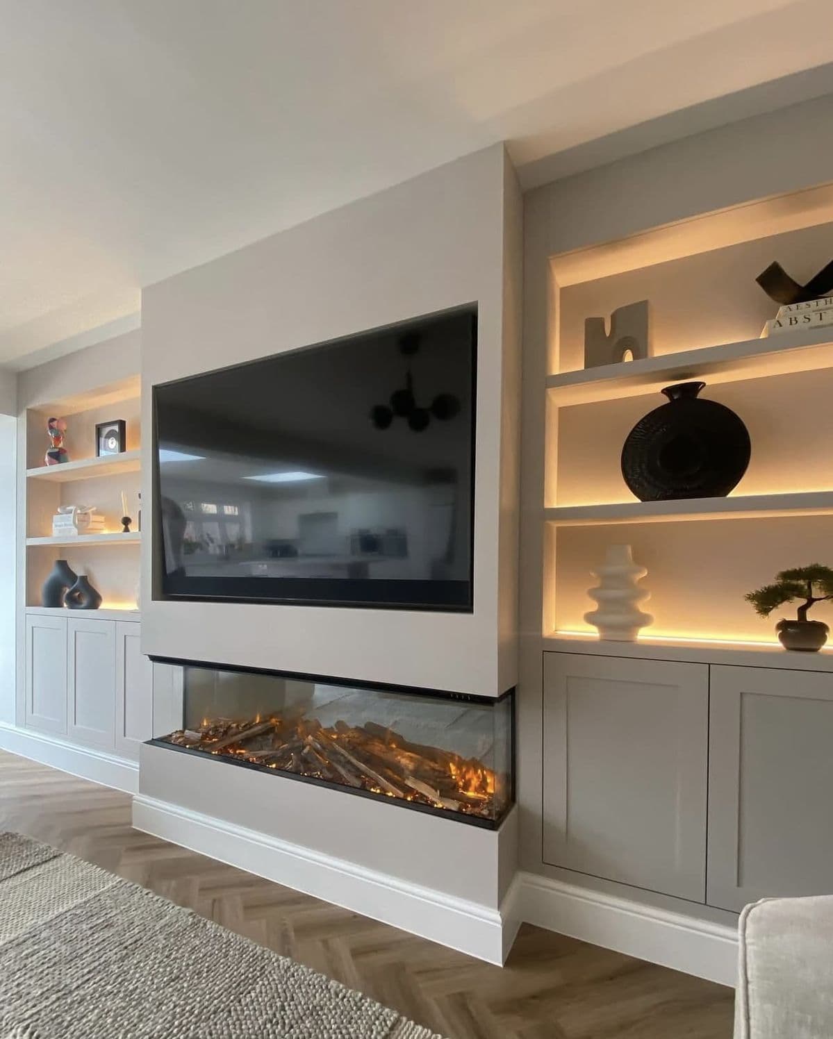 Contemporary media wall with integrated fire and built-in cabinetry